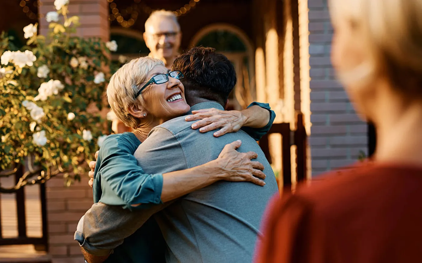 Happy senior woman embraces her son
